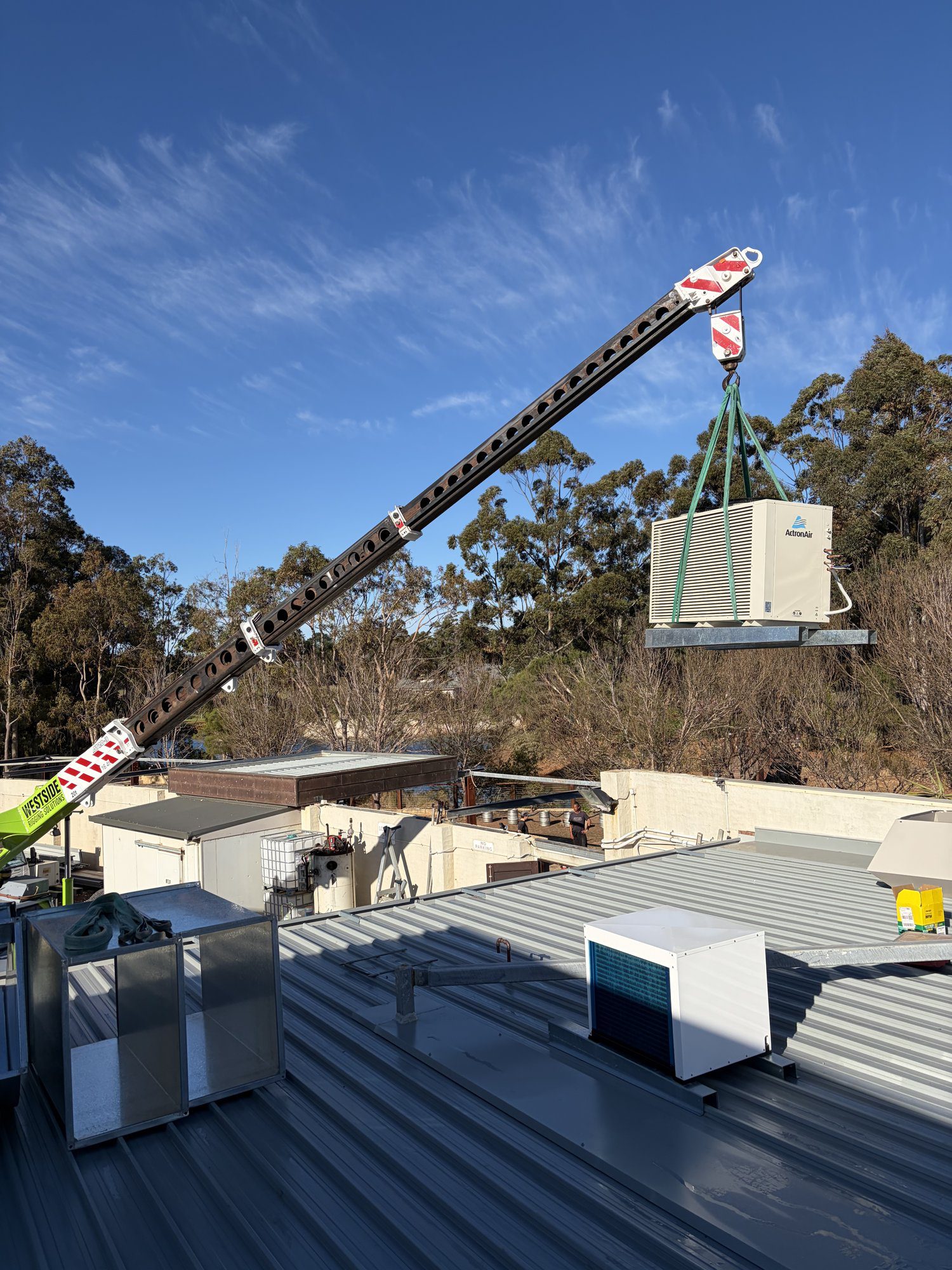 ActronAir commercial AC unit on the hook being placed on the roof, Back Roads Wilyabrup