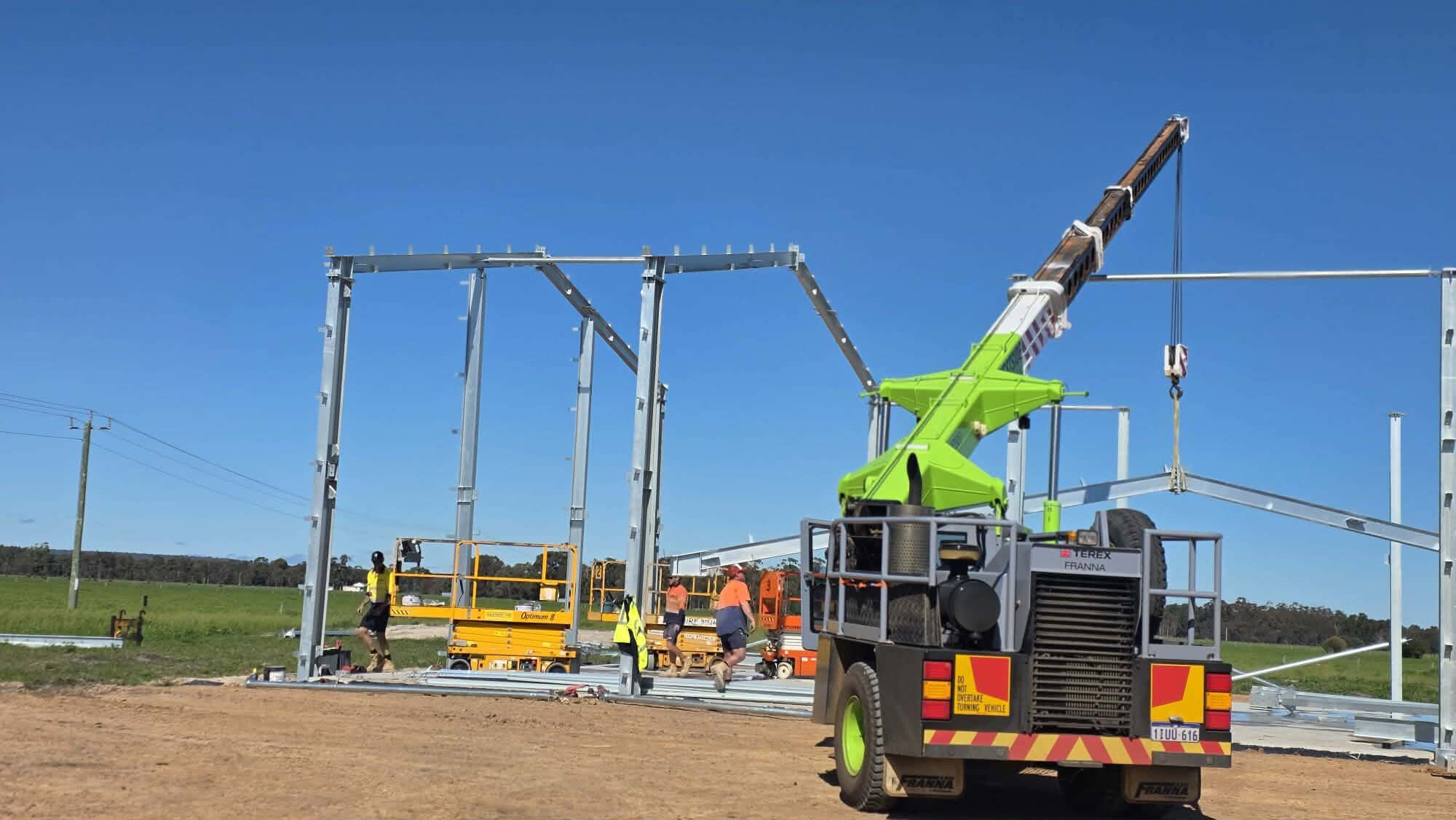 westside-rigging-franna-crane-shed-erection-vasse-3 Crew working the steel frame with EWPs, Vasse shed build